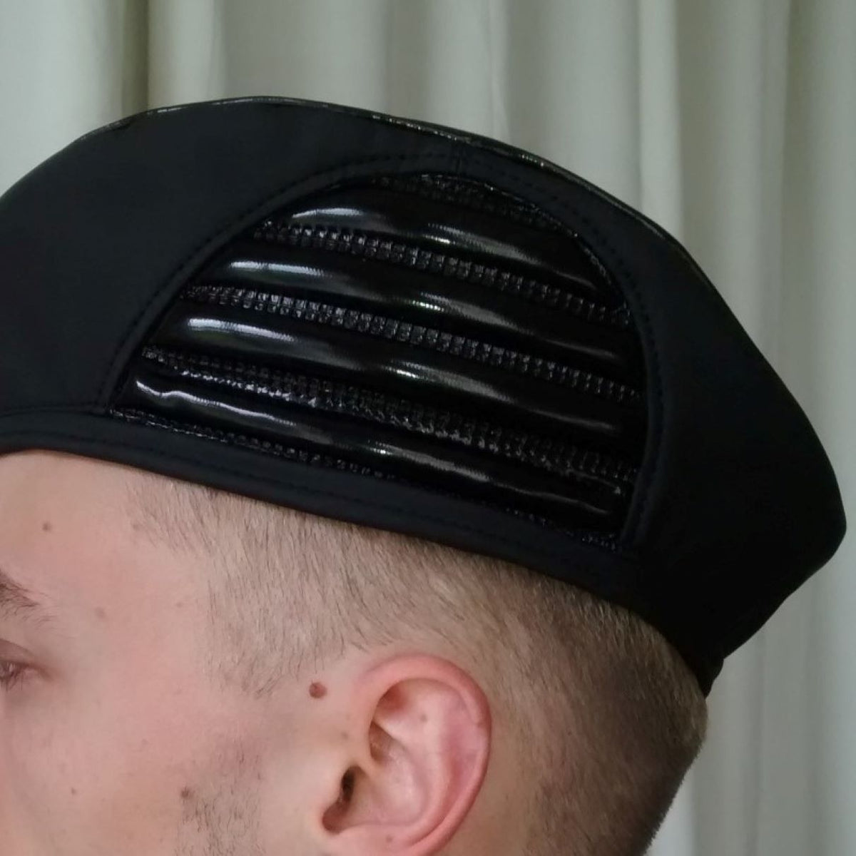 Baret – black PVC beret with glossy finish and ventilation ribs, top detail view