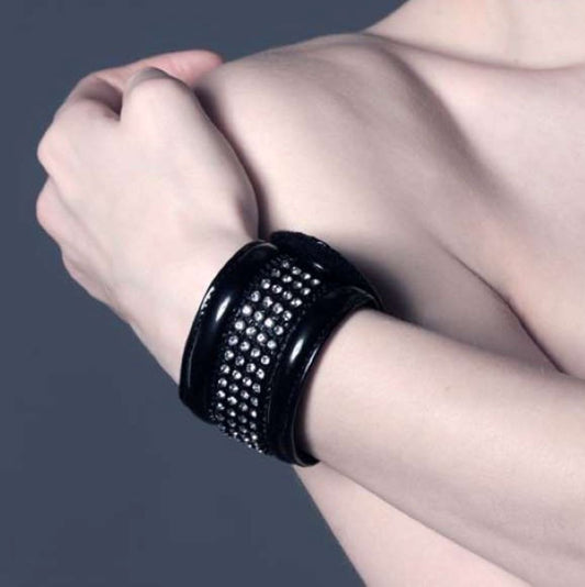 Blixx - glossy black patent cuff bracelet with rhinestone grid stud pattern, detail view