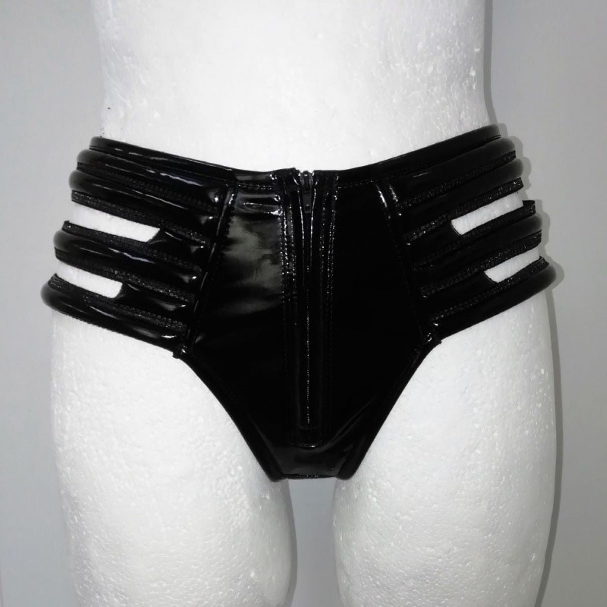 Panty - glossy black PVC brief with striped elastic side cutouts and central zipper, front view