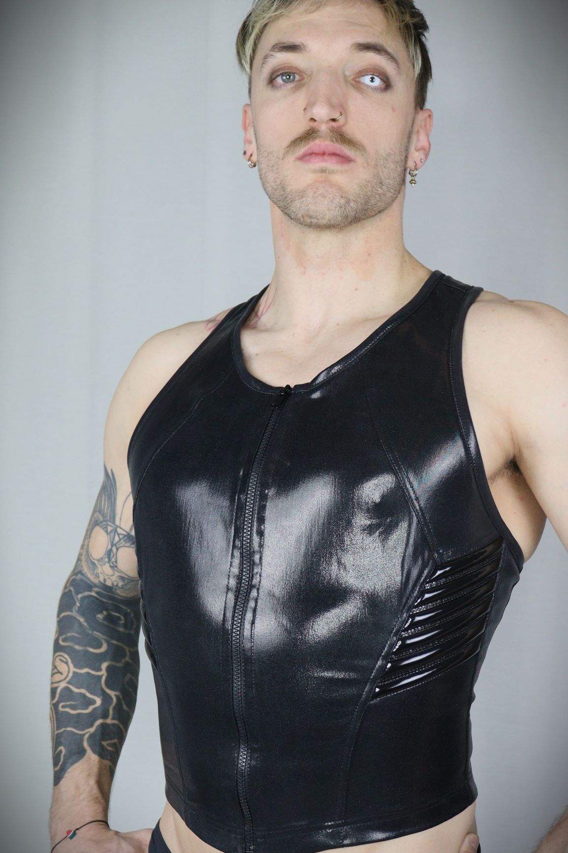 Serratus Top – glossy black leatherette sleeveless top with side-panel lacing, front view