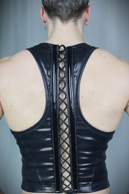 Serratus Top – glossy black leatherette sleeveless top with side-panel lacing, back view