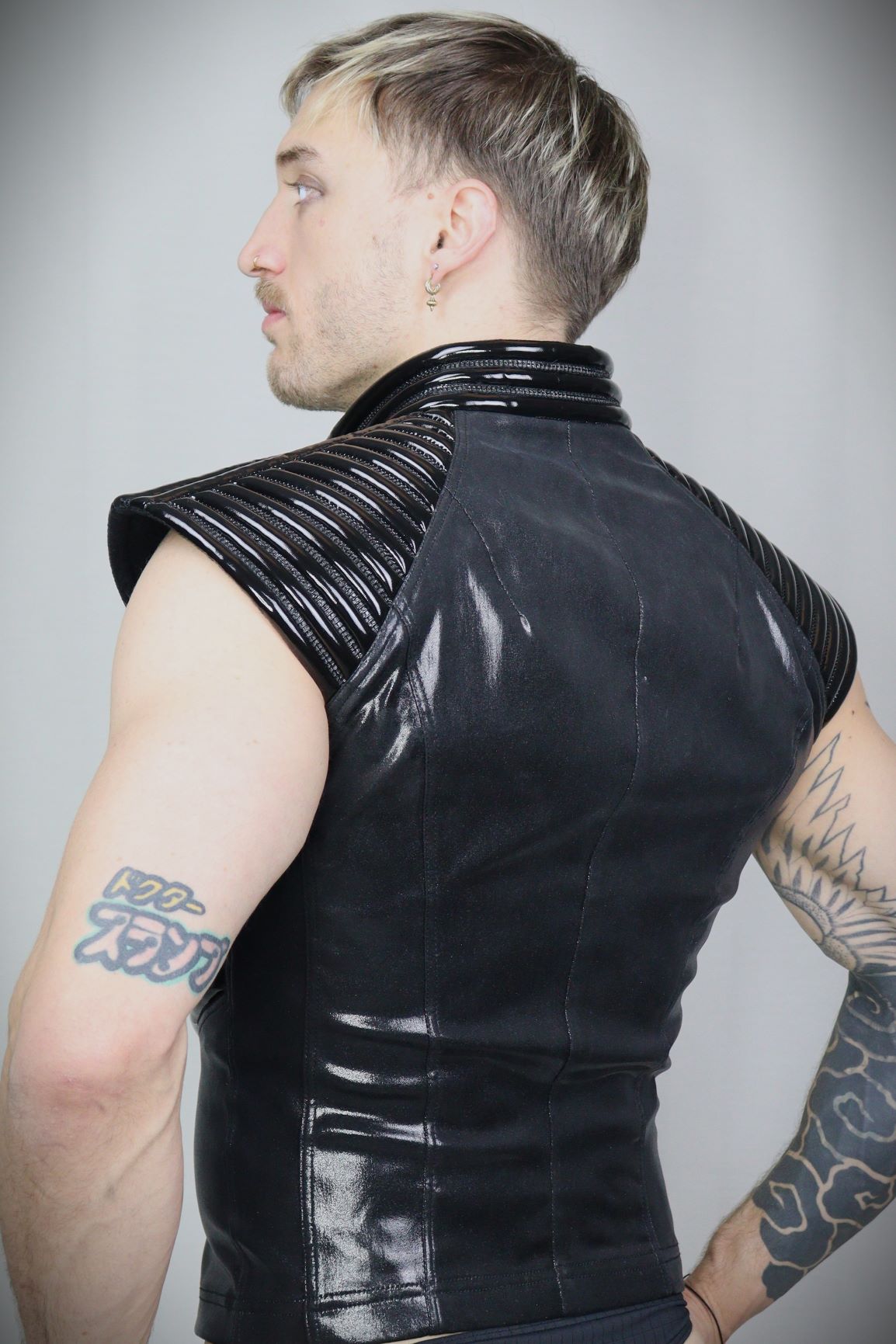 Thorax Top – glossy black leatherette sleeveless top with ribbed shoulder panels, back view
