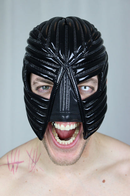 Warrior Mask – glossy black PVC with radiating ribbed crown structure, front view