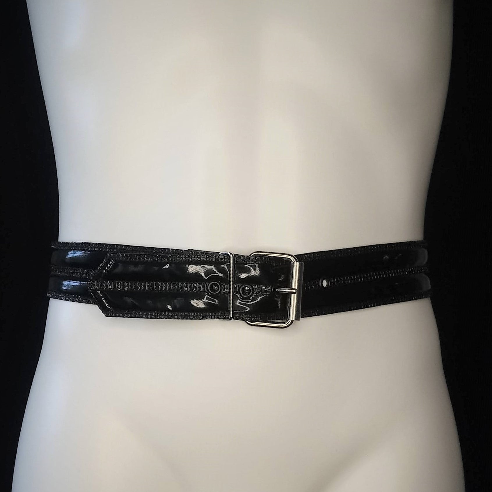 Belt – glossy black patent with rectangular metal buckle, front view