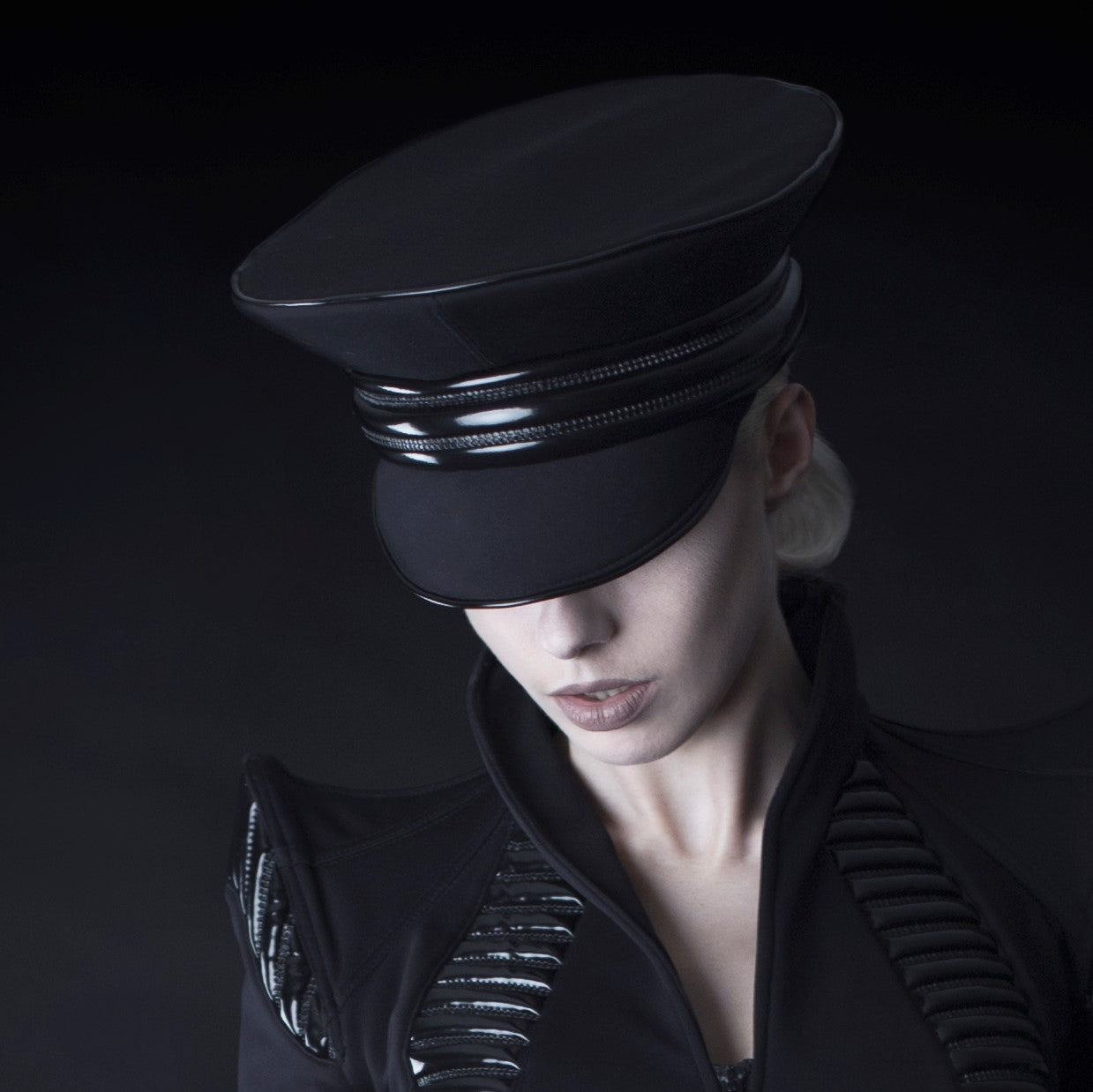 Cap in Softshell - black with glossy visor and metal trim band, front view