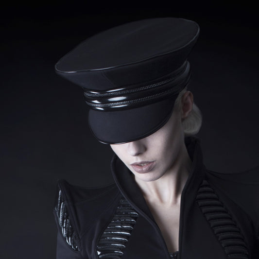 Cap in Softshell - black with glossy visor and metal trim band, front view