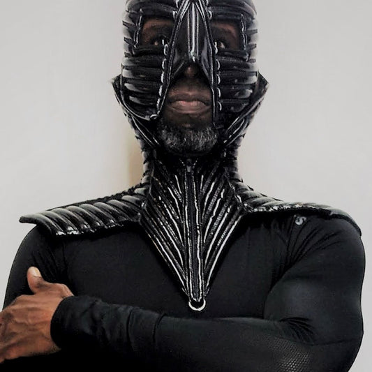 Collar – black PVC collar with strapped ribbed patterns and metal chains, detail view