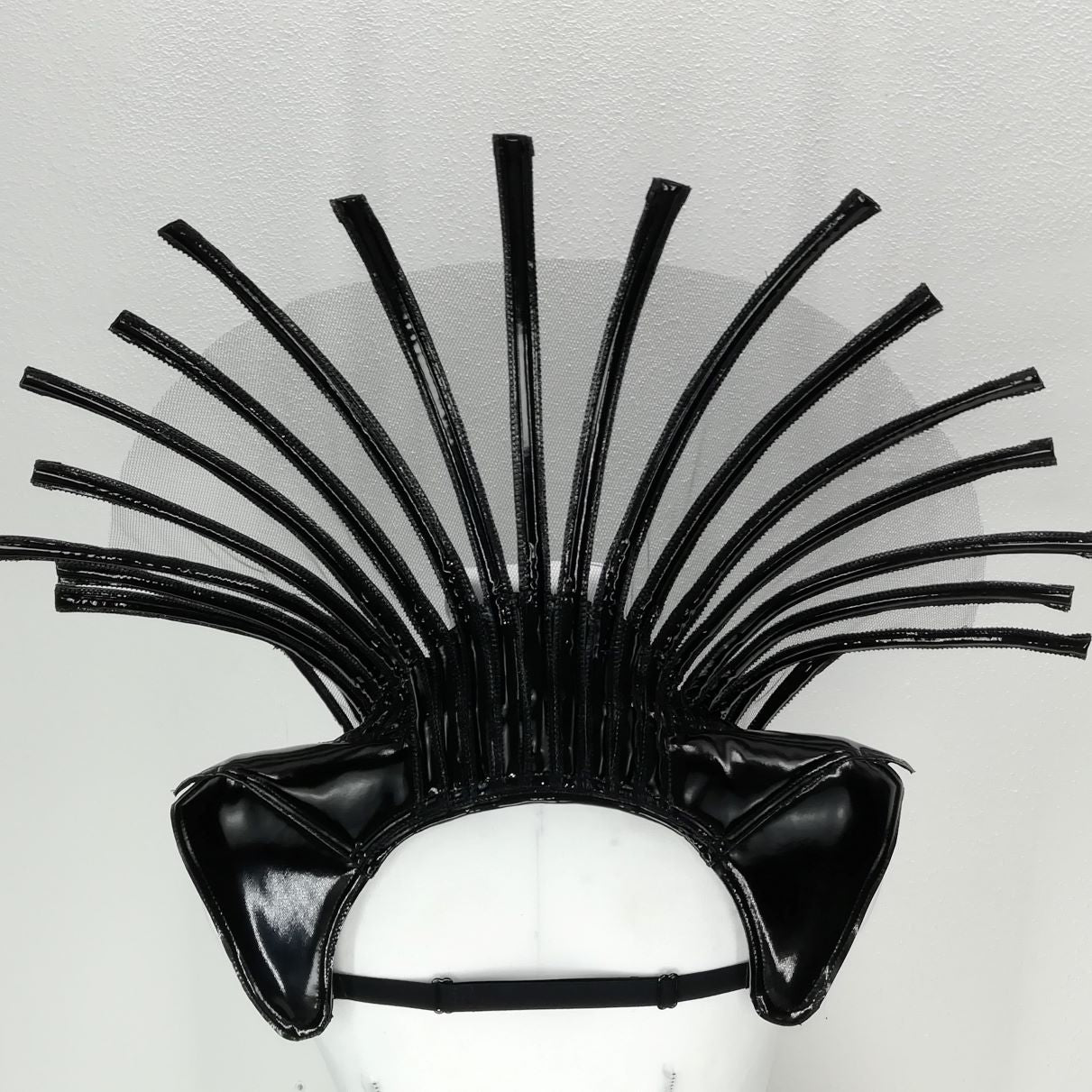 Comtesse DK – sculptural headpiece with fanned spiky tendrils, overhead view on display