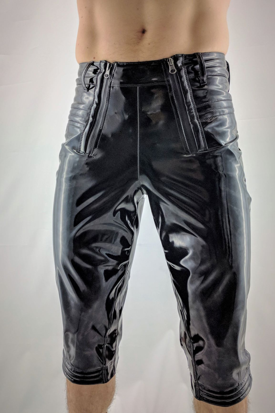 Knigger – glossy black PVC capri pants with striped side panels, front view