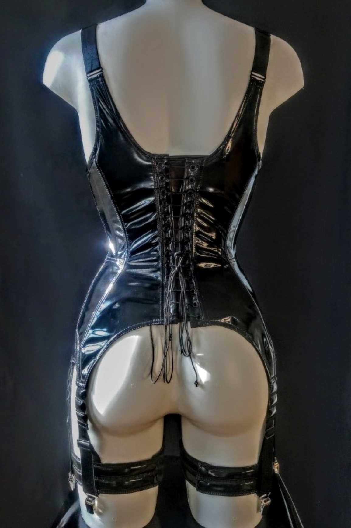 Madonna Torselette – glossy black patent open-back corset with garters, rear detail