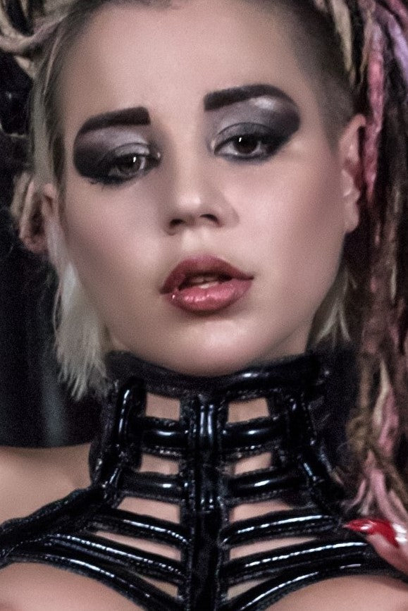 Nude Dress – black patent leather choker collar with horizontal ribbed texture, close-up