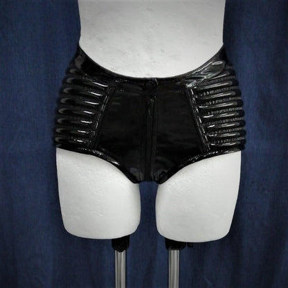 Hot Pant – glossy black patent leather shorts with ribbed panels and center zip, rear detail
